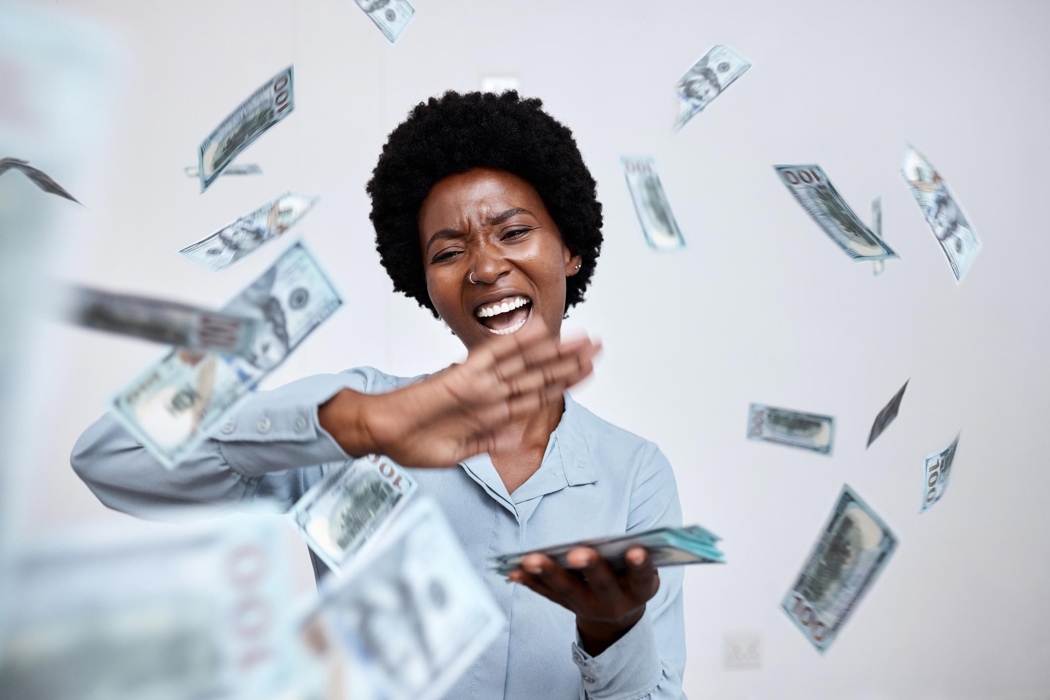 Solutions-Cash-Discount-Page-flying-cash-with-lady-iStock-1434356176 - Payscout Woman with dollars floating in the air